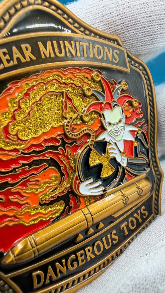 Macro detail of hand-filled enamel and raised relief on a challenge coin