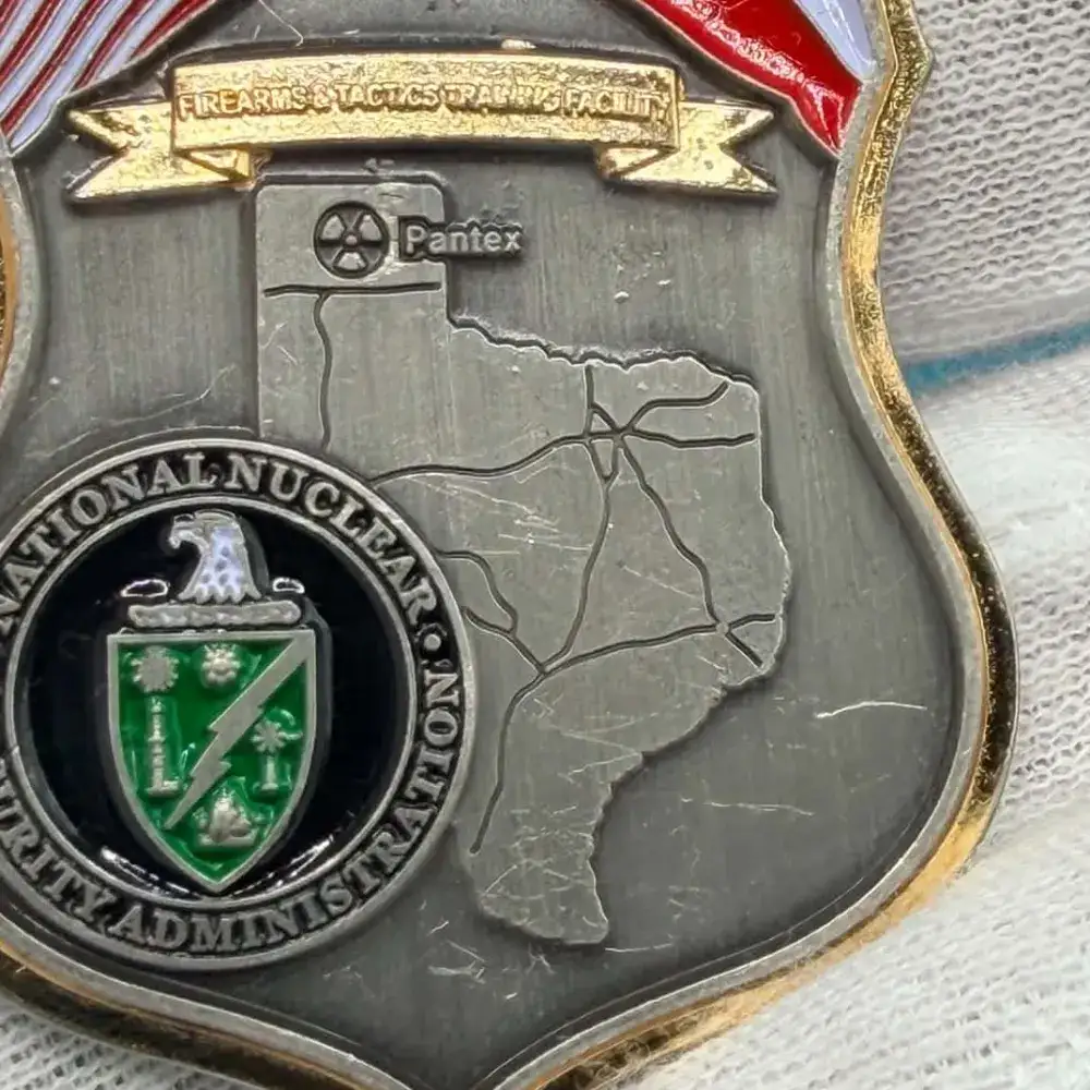Front of the Protective Force challenge coin reading Working Together to Secure the Nation