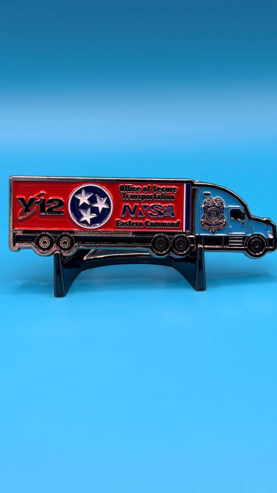 OST Twin Semi truck-shaped challenge coin with a red Y-12 NNSA Eastern Command trailer and sculpted silver tractor